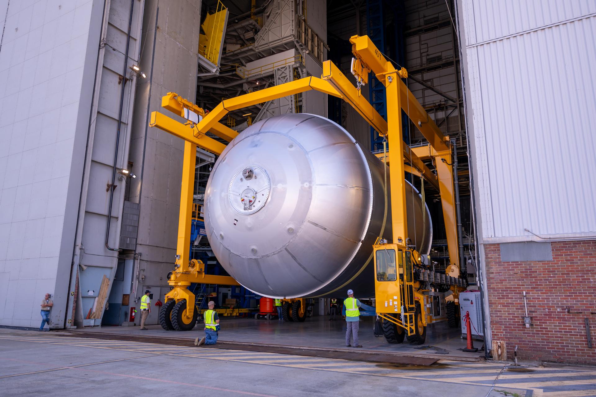 Teams at NASA’s Michoud Assembly Facility in New Orleans move a liquid oxygen tank from the main rocket factory into the adjacent vertical assembly building. The liquid oxygen tank, which will form part of the SLS (Space Launch System) rocket for NASA’s Artemis IV mission to the Moon, is rotated from a horizontal to a vertical configuration and loaded into the high bay’s hydrostatic proof testing cell. This non-destructive evaluation method tests the structural integrity of the tank’s welds by filling the tank with water, simulating the propellant used during launch. The propellant tank will hold more than 196,000 gallons of super-cooled liquid oxygen at launch and is one of five major elements that make up the 212-foot-tall SLS rocket stage. The core stage, along with its four RS-25 engines at its base, produces more than two million pounds of thrust to help launch NASA’s Orion spacecraft, astronauts, and supplies beyond Earth’s orbit and to the lunar surface for Artemis.